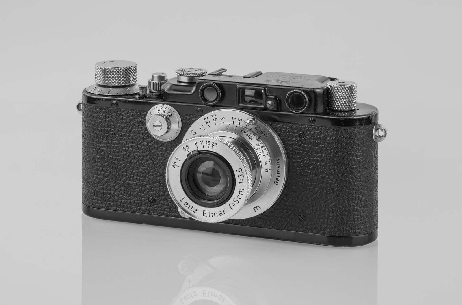 A black Leica III rangefinder camera from the 1930s with a Leitz Elmar lens