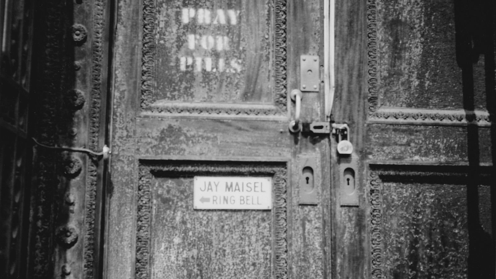 A weathered metal door at 190 Bowery with a small sign reading Jay Maisel, ring bell