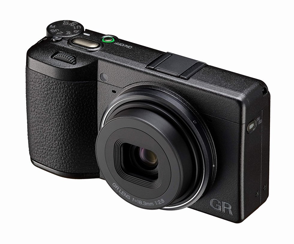 The Ricoh GR IV 30th Anniversary Edition at an angle, showing the top plate controls and the extended lens